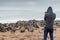 Hoody male photographer standing over ten thousands fur seals in