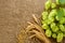 Hop cones, barley grain and wheat ears on burlap woven background with copy space for text, frame for brewing beer festival