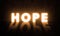 Hope Doors Concept. Glowing Hope letters On A Grungy Wall in a big Hall. Light Door Glowing Bright Letter