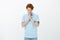 Hope god will hear my prayers. Portrait of charming hopeful young male with red hair, holding hands in pray and bowing