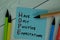 HOPE - Have Only Positive Expectations write on sticky notes isolated on Wooden Table