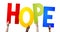 Hope - human hands holding colorful letters