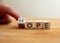 Hope or nope concept. Finger flips letter at wooden cube changing the word nope to hope