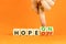 Hope on or off symbol. Businessman turns wooden cubes and changes word Hope off to Hope on. Beautiful orange table orange