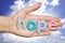 Hope word from colourful letters on womanâ€™s hand with clear blue sky as background