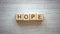 Hope word made of cubes, pure and genuine belief in god, prayers and blessings