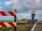 A hopeful teddy bear is sitting at a railway crossing and looks into the distance with great desire.Travel, loneliness or  safety