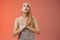 Hopeful worried concerned faithful blond woman in silver dress praying talking god wishing family okay press palms