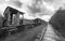 Hopeless post apocalyptic landscape. Cemetery of abandoned broken trains. Monochrome photo