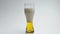 Hoppy unfiltered drink foaming slow motion. Alcoholic beverage pouring glass