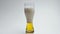 Hoppy unfiltered drink foaming slow motion. Alcoholic beverage pouring glass