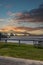 The Horace Wilkinson Bridge over the flowing waters off the Mississippi River with boats on the water, lush green grass