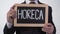HoReCa written on blackboard in businessman hands, catering service industry