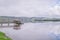 Horeke Hokianga Harbour and pier on a cloudy overcast day, in Fa