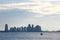 The horizon of a city scape buildings at dusk over the sea line