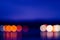 Horizon with reflection of circle bokeh lights blur at night across lake