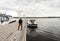 horizon river girl in leather jacket and trousers autumn walk pier pier boat boat clear light sky water surface