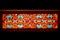 horizontal arabesque pattern with mosaic glass style window, in red and orange back lit colors,Generative AI