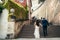 The horizontal back view of the beautiful newlyweds going up the ancint stairs of Prague.