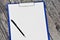 Horizontal clipboard with blank white paper and pen