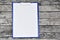 Horizontal clipboard with blank white paper on wooden
