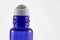 Horizontal Close-Up of Blue Glass Essential Oil Roller Bottle