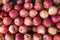 Horizontal close up of a crate of red and golden organic apples