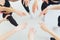 Horizontal close up photo young people girls and guys hold stack hands together high five gesture symbol of support