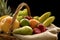 Horizontal Closeup detail on a basket full of fruit on a dark background