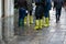 Horizontal closeup photo of tourists feet in high shoe covers protecting their feet from rain