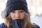 Horizontal closeup of pretty young girl in warm coat and wooly hat