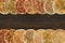 Horizontal collage of different baked pizzas on dark wooden table