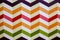 Horizontal colorful zigzag lines on the white background. Real strips painted on wall. Bright zig zags for wall paper. Children