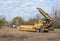 Horizontal Grinder with Log Truck During Deforestation