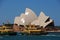 Horizontal image Sydney Opera House with ferry rides, shining shell reflection surface from strong sun, New South Wales, Australia