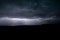 Horizontal lightning bolt is visible below the clouds of an active thunderstorm in eastern Montana