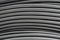 Horizontal lines of black electric cable. Abstract textural industrial background. Coils of black wires are close-ups