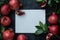 Horizontal mockup with pomegranates and free space for text in the middle. White sheet of blank paper, bright juicy pomegranate,