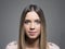 Horizontal moody portrait of pretty young woman with ombre hairstyle looking at camera