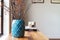 Horizontal moroccan teal vase with clear space for text on white