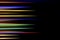 Horizontal multicolor light rays on a black background. Long exposure photo