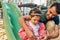 Horizontal outdoor image of cute daughter playing with her handsome father outdoors. Dad and little girl playing at playground