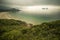 Horizontal outdoors shot of forest and sandy coast from above.