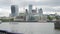 Horizontal pan of modern office buildings along River Thames, out of focus