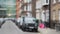 Horizontal pan of residential street with cute townhouses in London, defocused