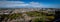 Horizontal Panorama of Princes Street from the inside of the Edinburgh Castle, with the castle grounds full of people in
