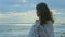 Horizontal panorama of stormy sea and beautiful lonely woman standing on beach