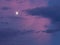 Horizontal photo moon lit with blue and pink clouds