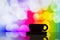 Horizontal photo of silhouette coffee cup on colorful bokeh back