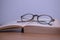 Horizontal photography in vintage style glasses and an old yellowed book